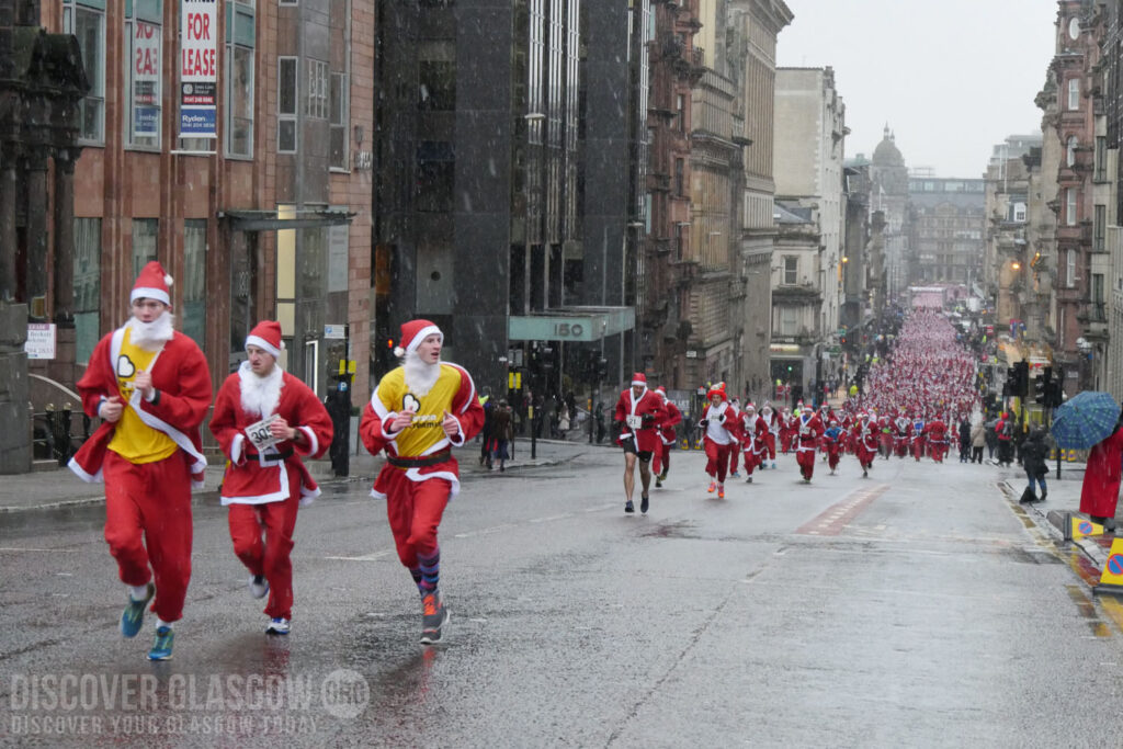 Santas jogging up St. Vincent Street in Glasgow