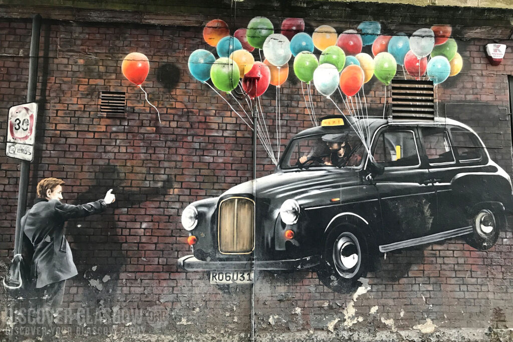 A graffiti art drawing of a taxi being lifted by balloons.